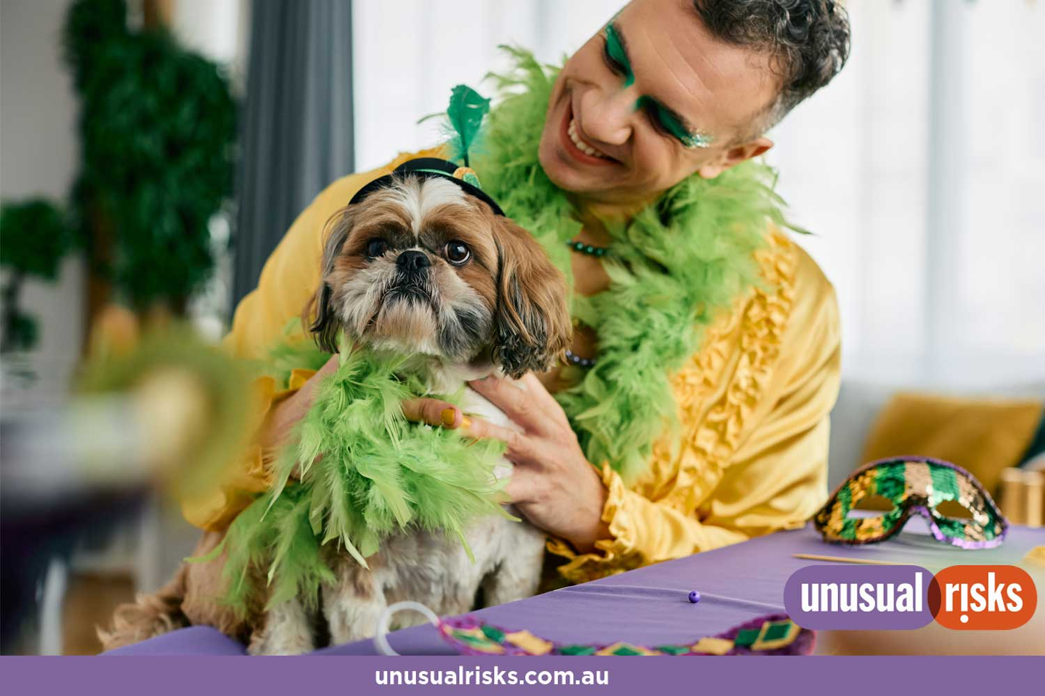 spoilt small dog wearing feather boa to match their happy owner