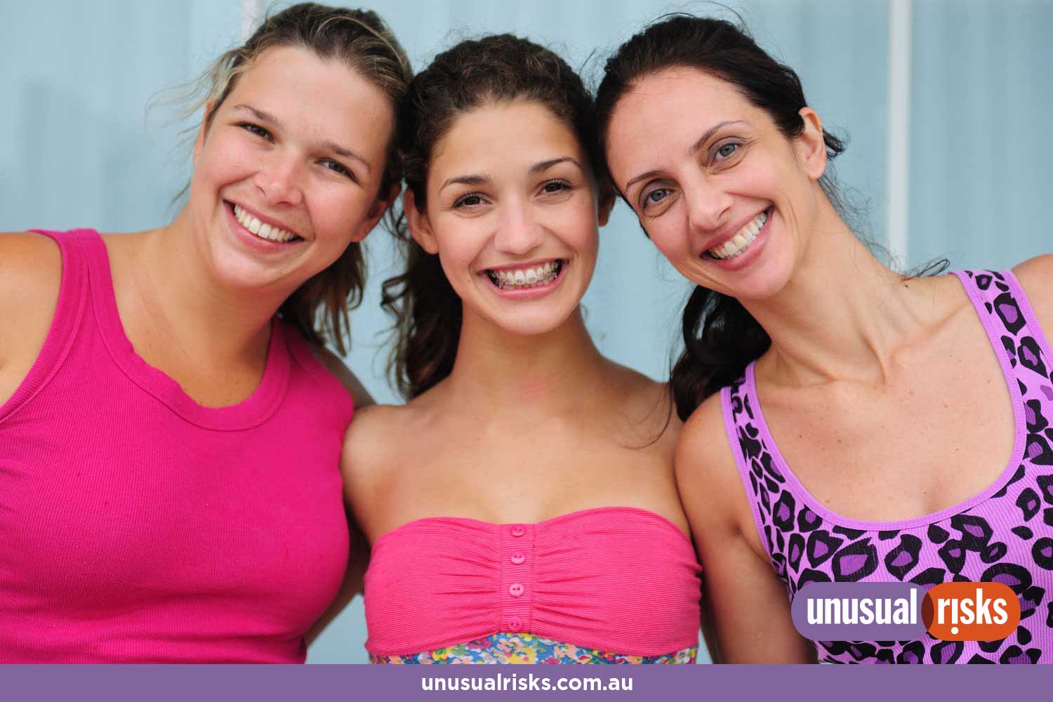 three smiling women of different ages wearing colourful pink sportswear