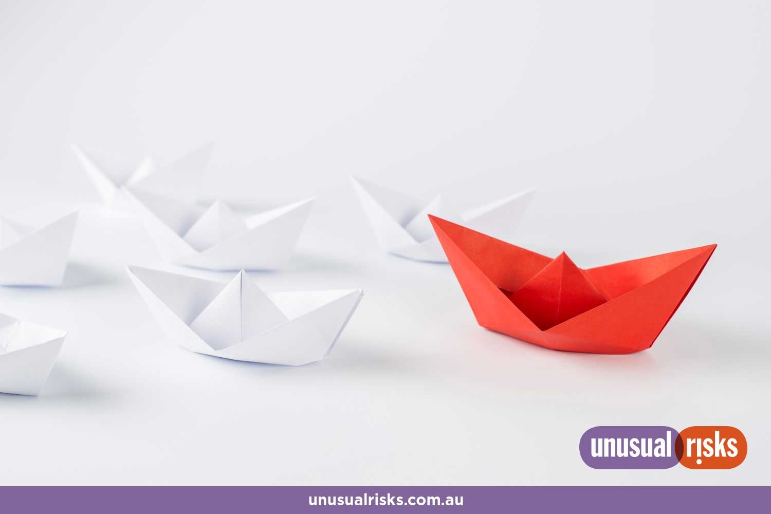 white paper boats with a red boat leading