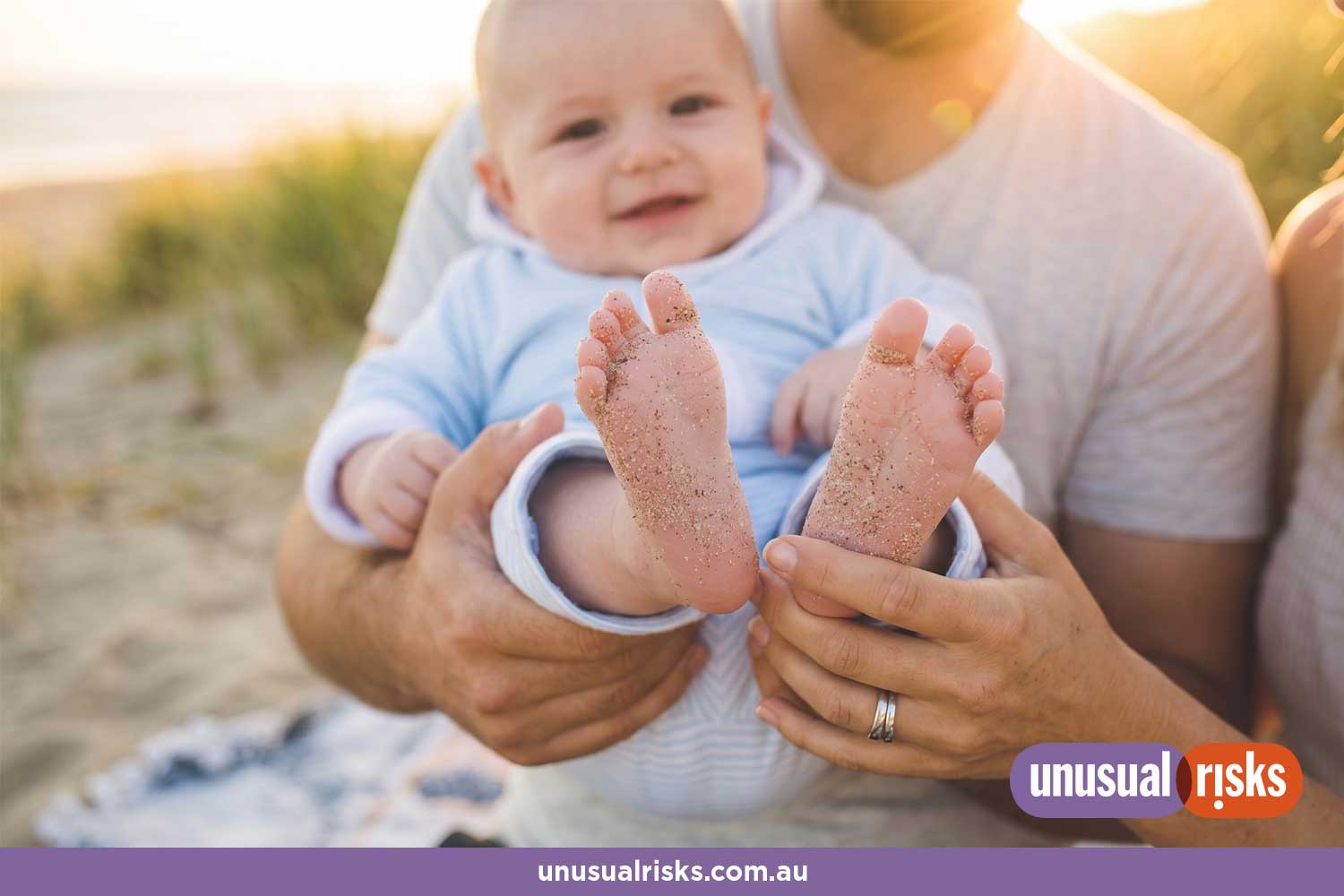 happy baby and parents on the beach